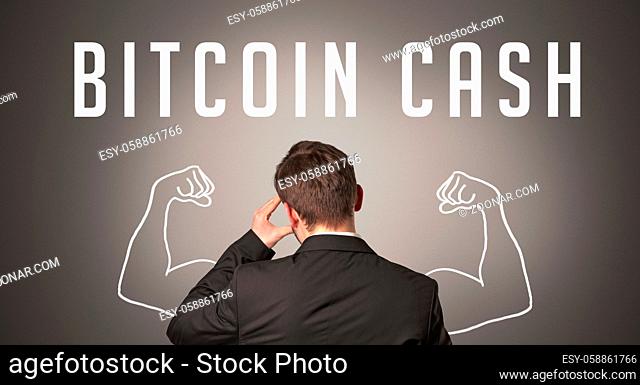 Rear view of a businessman with BITCOIN CASH inscription, powerfull business concept