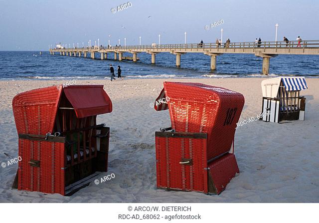 Wicker Beach Chairs and people on beach at seabridge Zinnowitz Isle Usedom Mecklenburg-Western Pommerania Germany