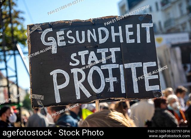 09 October 2021, Berlin: Participants carry banners and posters at a demonstration of the Berlin hospital movement under the motto ""We help you - Who saves...