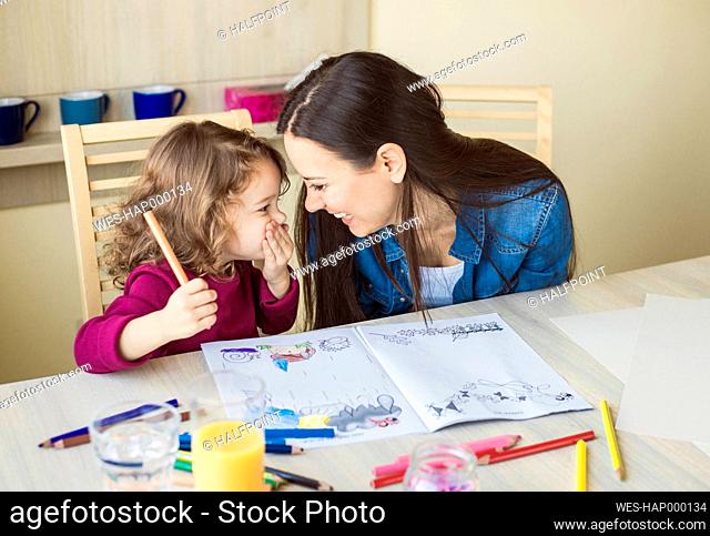 Little girl laughing together with her mother