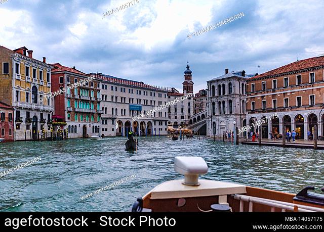 a trip down the grand canal in venice in a water taxi. the so-called vaporetto is a primary mode of public transport and operates 24 hours a day
