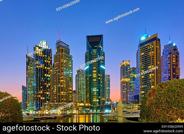 Dubai Marina and harbour at sunset - Illuminated modern towers in the evening, United Arab Emirates