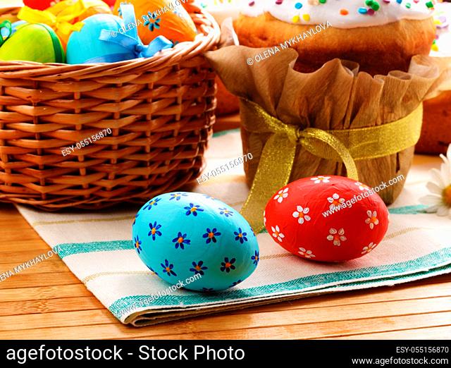 Easter decorations - eggs, cake and basket on the tabletop