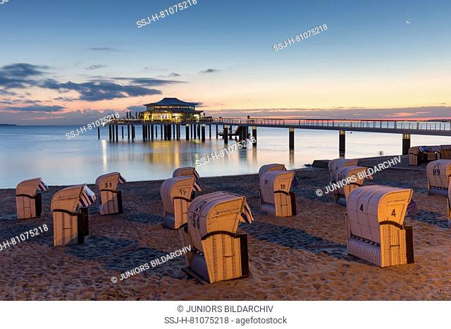 Seabridge with restaurant at dusk. Timmendorfer Strand, Schleswig-Holstein, Germany