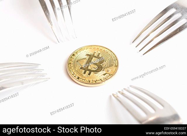 Macro photo of Bitcoin cryptocurreny fork concept with reflection, hard fork