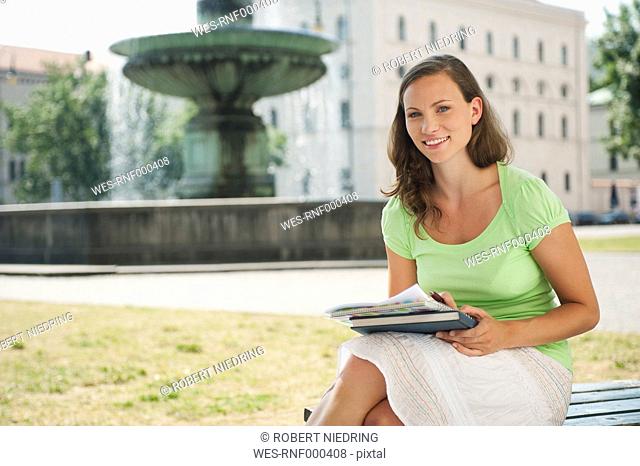 Germany, Munich, Young woman smiling, portrait