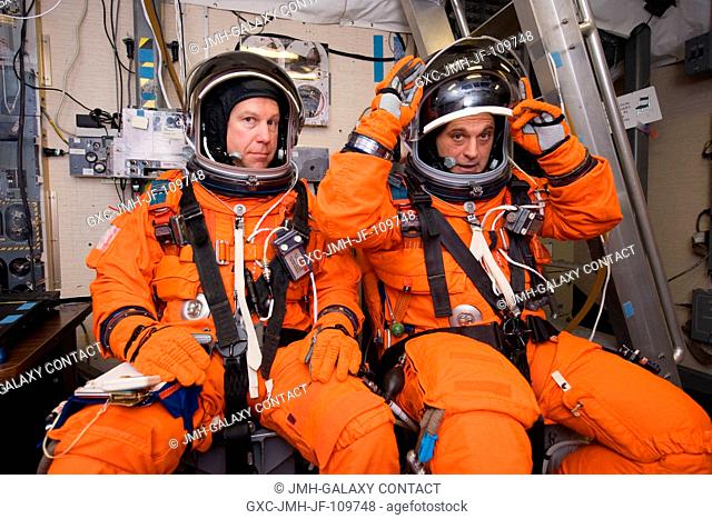 Astronauts Tim Kopra (left) and Dave Wolf, both STS-127 mission specialists, attired in training versions of their shuttle launch and entry suits