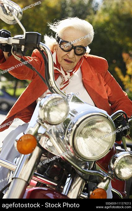 Elderly woman driving a motorcycle
