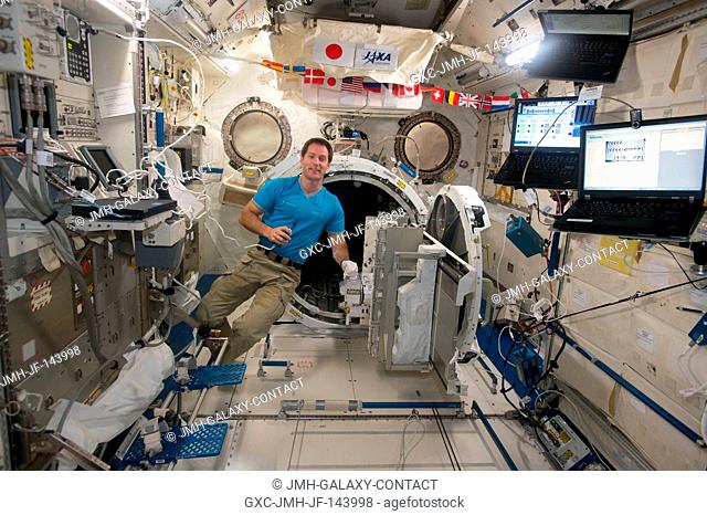 ESA (European Space Agency) astronaut Thomas Pesquet floats next to the airlock inside the Japanese Experiment Module aboard the International Space Station