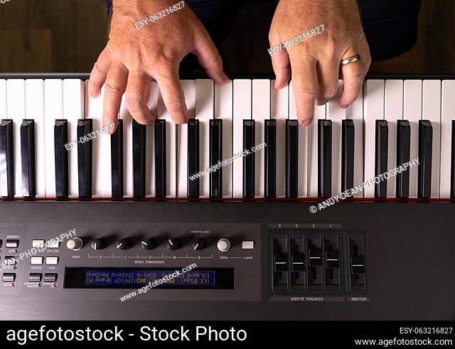 Male Hands Practicing on the Electronic Piano Keyboard
