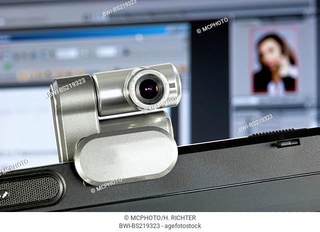 webcam installed on computer monitor, screenshot with portrait of a woman in the background