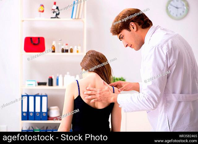 Female patient visiting young handsome doctor chiropractor