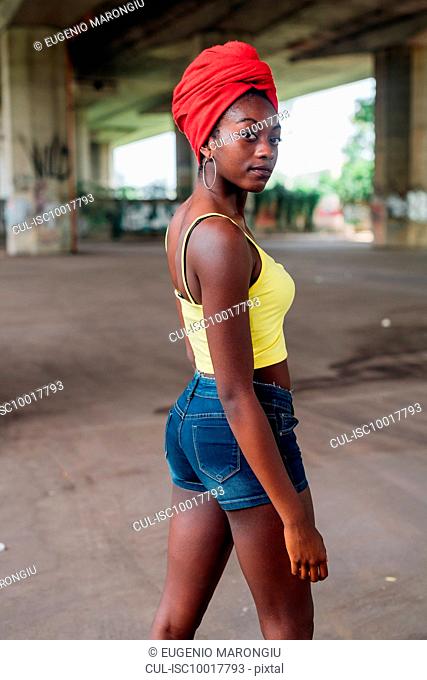 Woman posing under bridge