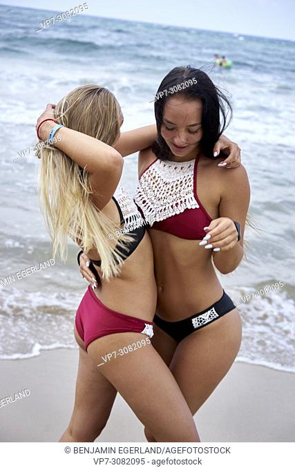two women on beach, wearing bikini, feeling sexy, togetherness. Greece, Crete, Malia