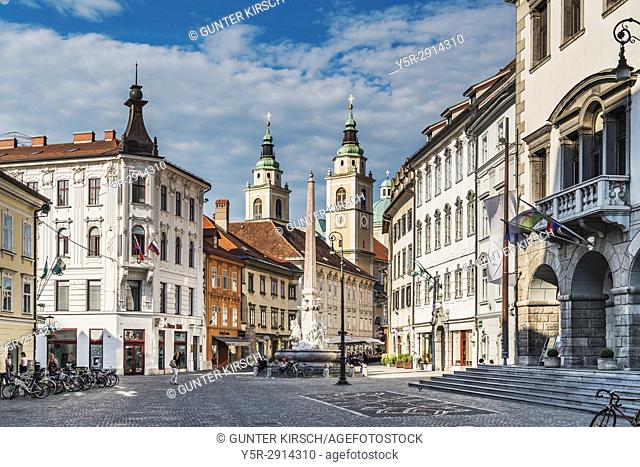 View over the town hall square, Mestni Trg, to St. Nicholas Cathedral. The Baroque cathedral is dedicated to Saint Nicholas of Myra, Ljubljana, Slovenia, Europe