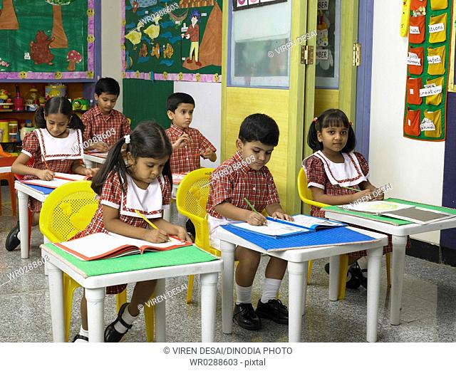 South Asian Indian boys and girls studying in nursery school MR