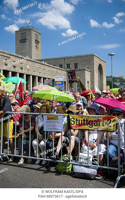 Demonstrators sit behind a barrier during a protest against the building project Stuttgart 21 in front of the central station in Stuttgart, Germany