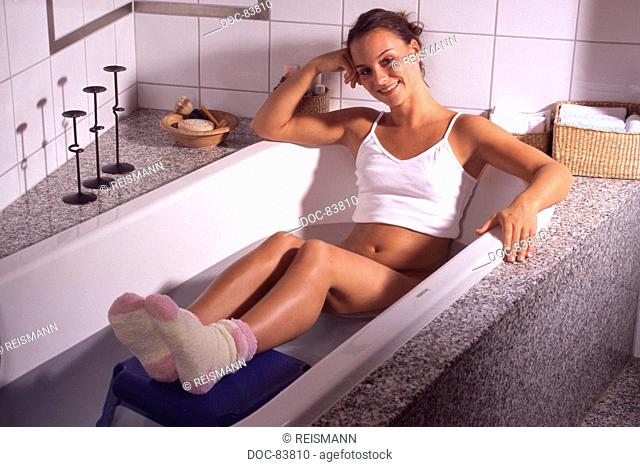 Young woman is taking a hip bath according Kneipp
