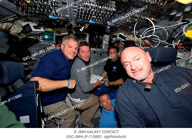 STS-134 crew members are busy on the aft flight deck of space shuttle Endeavour during undocking and fly-around operations with the International Space Station...