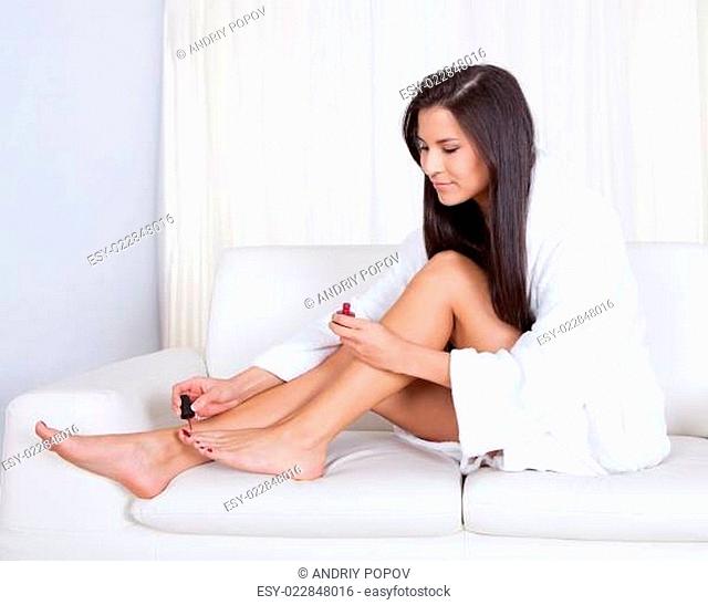 Woman varnishing her toenails