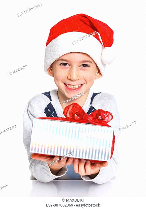 Christmas theme - Closeup portrait of smiling boy in Santa's hat with gift box, isolated on white