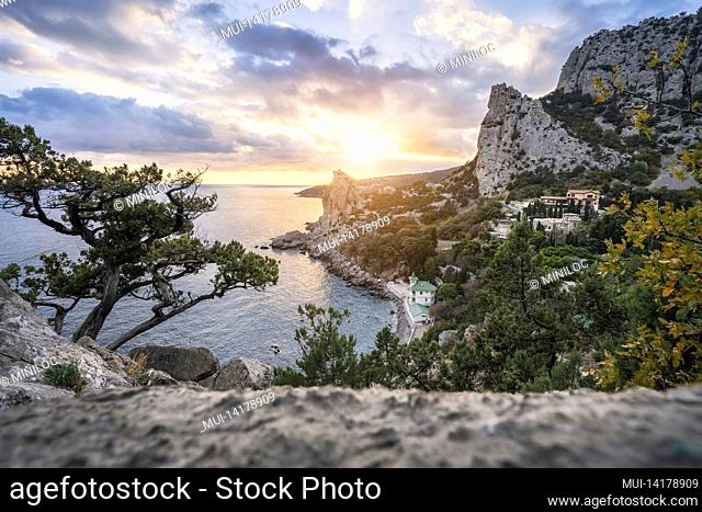 Golden sunset from Panea cliff with mountain cat koshka in background. Simeiz, Crimea. Black Sea