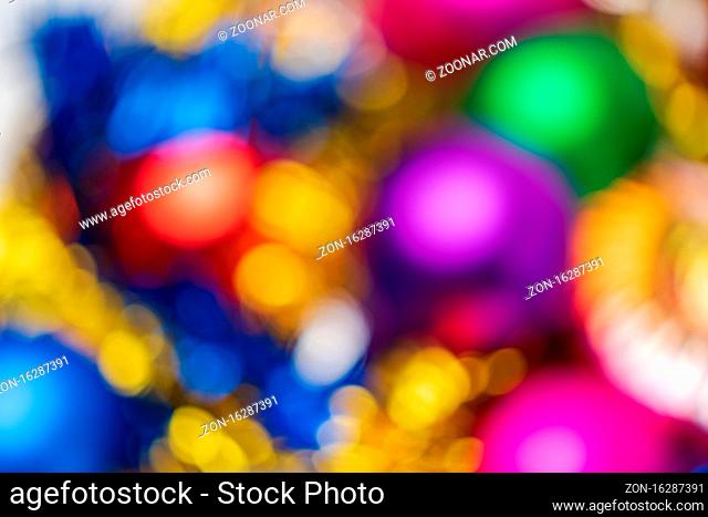 Defocused shining Christmas balls holiday decorations, abstract blurry bokeh background effect. Out of focus glowing lights celebration texture for use at...