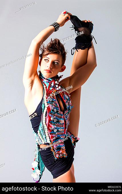 pretty brunette punk woman in an athletic and flexible pose