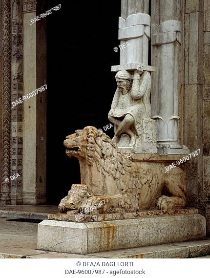 Lion and Telamon figure, main doorway, decorative detail of the facade of St George the Martyr Basilica, Ferrara, Emilia-Romagna. Italy, 12th century