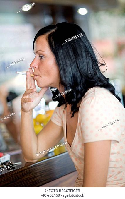 young woman smokes in cafeteria. - 12/08/2008