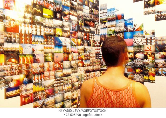 Young man watching a contemporary exhibition in the trendy area of Bairro Alto, Lisbon, Portugal