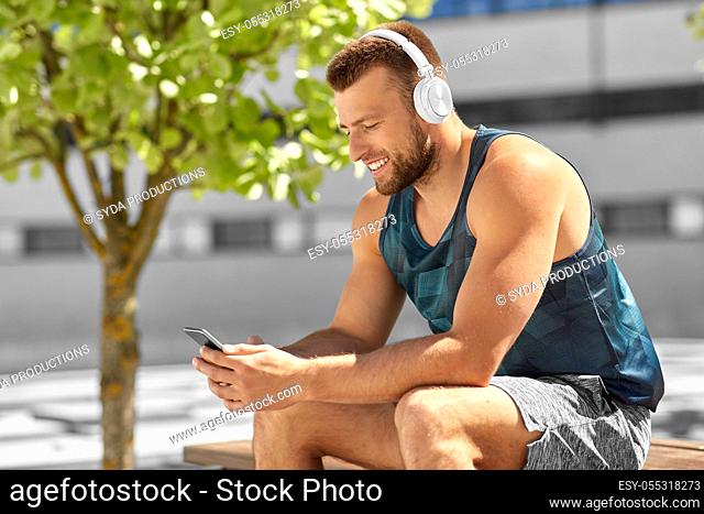 young athlete man with headphones and smartphone