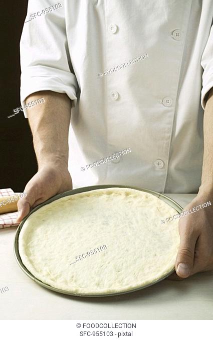 Pizza dough in baking tin
