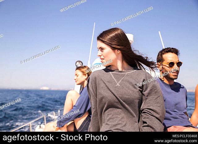 Friends enjoying vacation on boat at sunny day