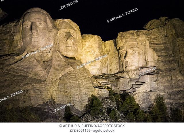 Evening illumination of Mount Rushmore. Mount Rushmore National Memorial featuring a 60-foot granite sculpture of the faces of four presidents: George...