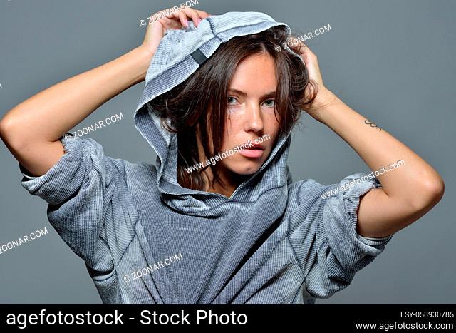 Torso Portrait of the beautiful sexy woman in grey hoody blouse