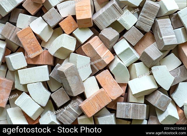 A pile of varied color miniature toy bricks as the background. Construction concept