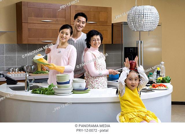 Portrait of a family smiling in kitchen