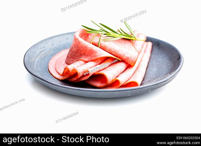 Sliced smoked salami on plate isolated on white background
