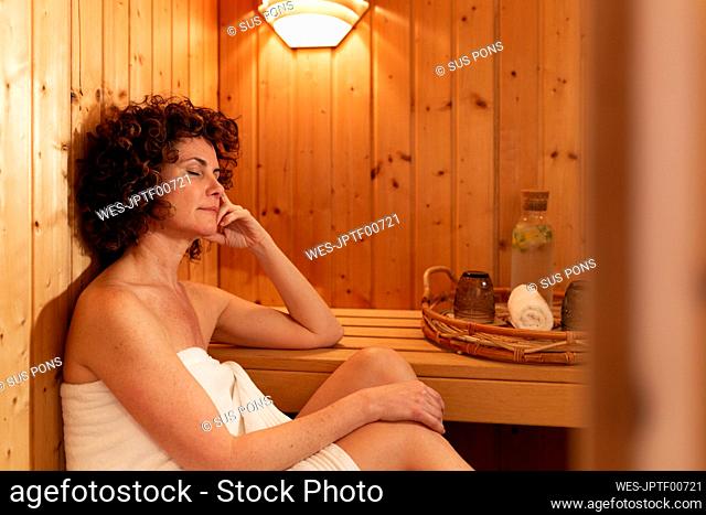 Mature woman relaxing in sauna