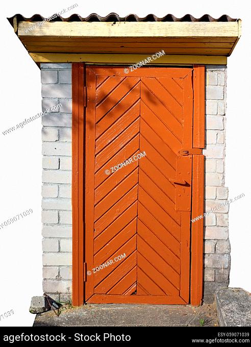 Orange painted wooden broken door in the small rural no name stone shed. Isolated on white