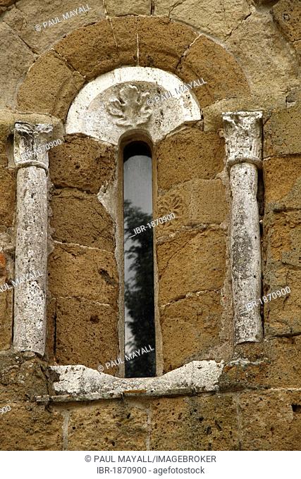 Small window with columns outside the Romanesque cathedral Santi Pietro e Paolo, Sovana, Province Grosseto, Tuscany Italy, Europe