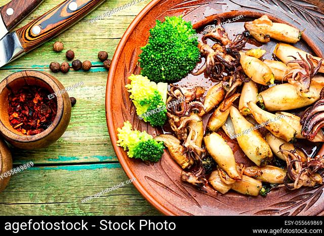 Squid stuffed with broccoli and mushrooms on a plate