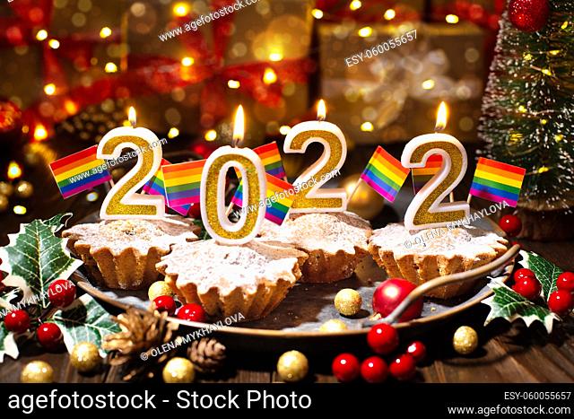 Food tray with cupcakes new year candles and gay flags decorations