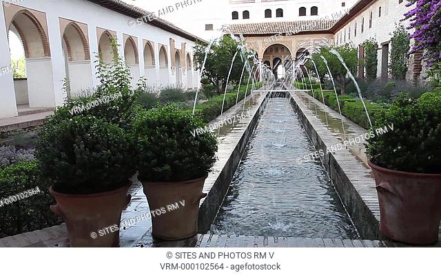 PAN, exterior, daylight. View towards the North Pavilion. Water fountains. Generalife Palace was the summer palace and country estate of the Nasrid Sultans of...