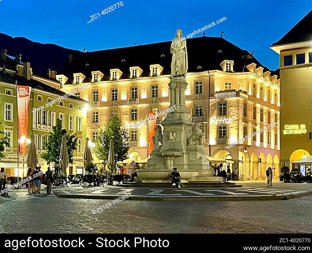 Walther Square in Bolzano in South Tyrol. with Monument to the poet Walther von der Vogelweide in the evening - Italy
