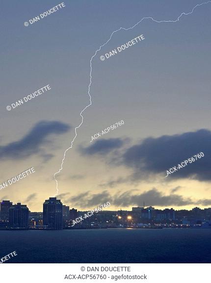 A bolt of lightning strikes Purdy's Wharf Tower II along the Halifax Harbour waterfront in Halifax, Nova Scotia