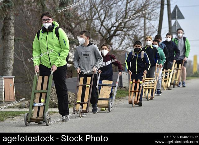 Children walk with their rattles through the streets of Branisovice, Czech Republic on Good Friday, April 2, 2021. Rattles replace the sound of bells which are...