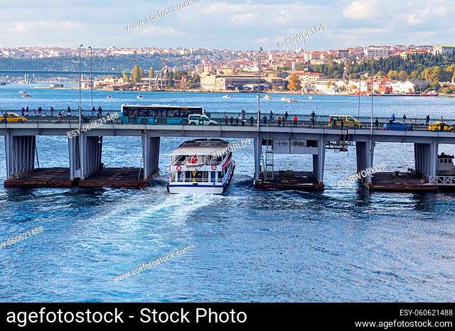 Ferry boat ship passes under the Unkapani Bridge at Golden Horn bay, Istanbul, Turkey