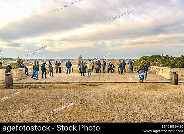 ROME, ITALY, DECEMBER - 2017 - Group of tourist watching and taking photos of Rome cityscape from monte pincio viewpoint